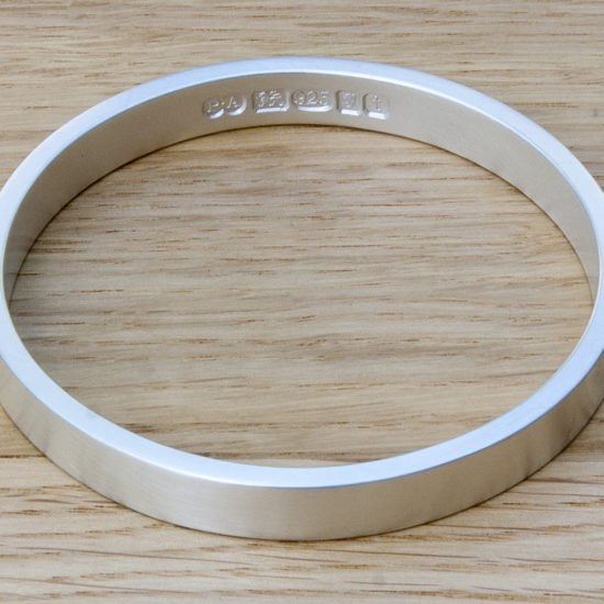 Zennor 8 Chunky Solid Silver Bangle Bracelet, it is Handmade with outside display London Hallmarks - 8mm wide.