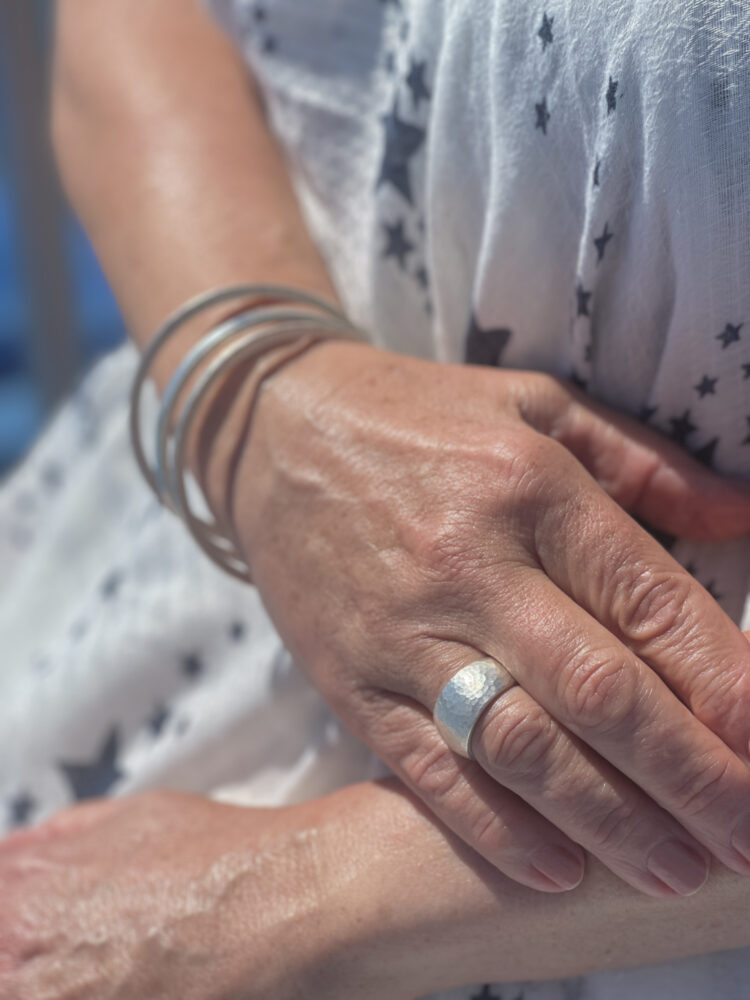 Hand Model Wearing The Pebble Chunky Wide Hammered Sterling Silver Ring Handmade in Cornwall, London Hallmarked